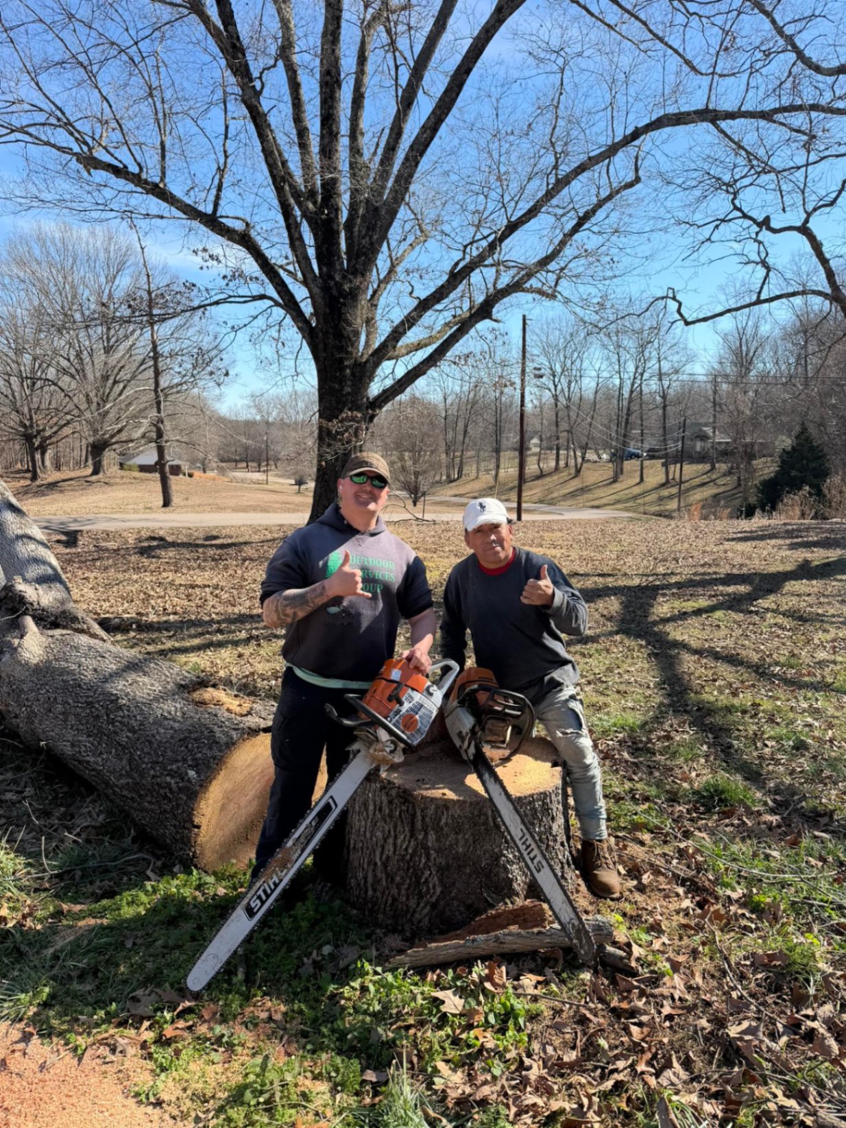 Outdoor Services Group crew with chainsaws ready for tree service work